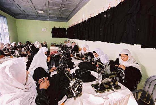 Women sewing school uniforms in an Afghan workshop